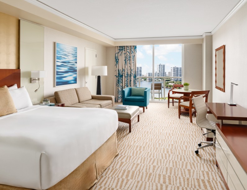 a hotel room with a large bed and a desk