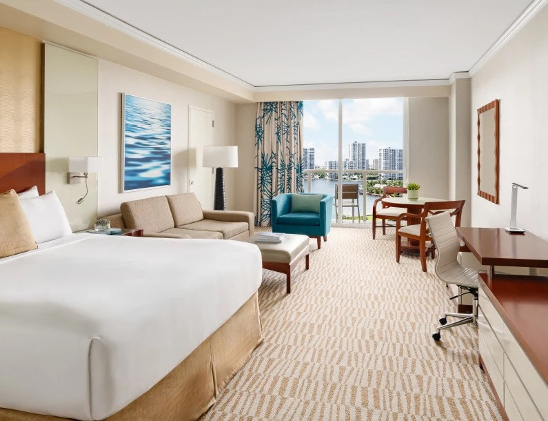 a hotel room with a large bed and a desk