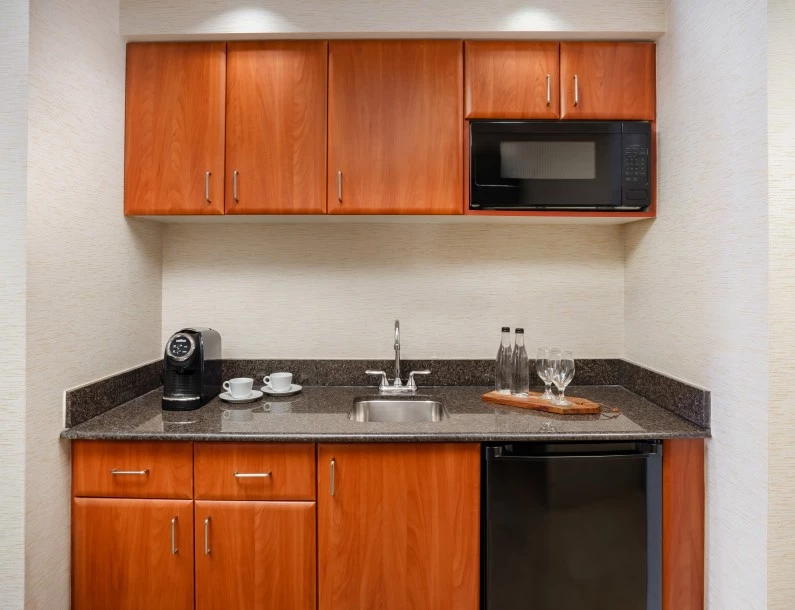 a kitchen with a microwave and a black dishwasher