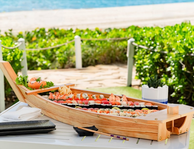 a wooden boat with sushi on it