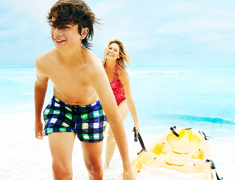 mom and son carrying kayak