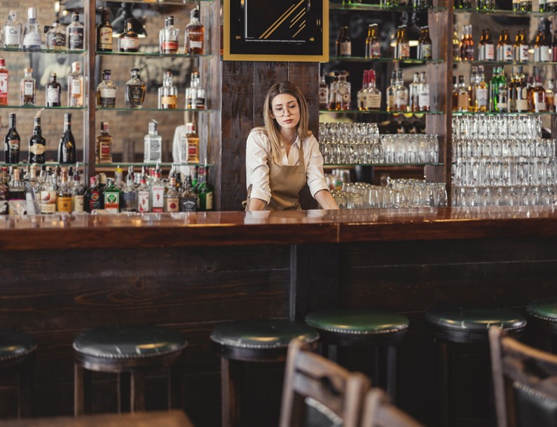 a woman behind a bar