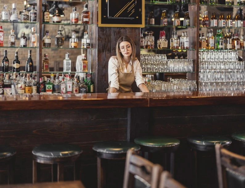 a woman behind a bar