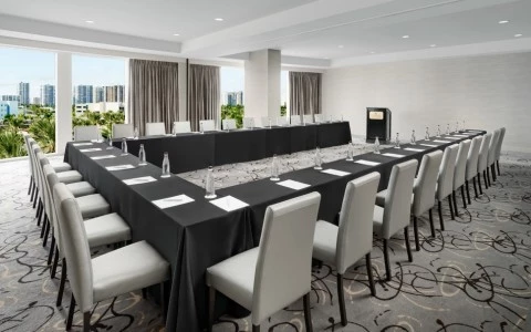 a large conference room with a black table and chairs