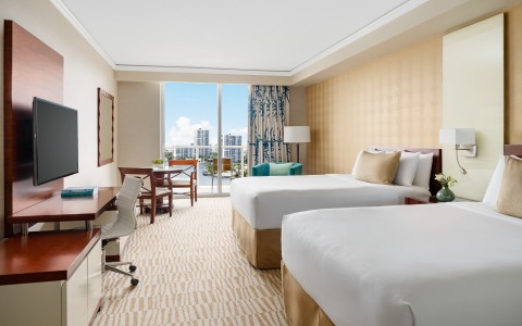 a hotel room with two beds and a desk