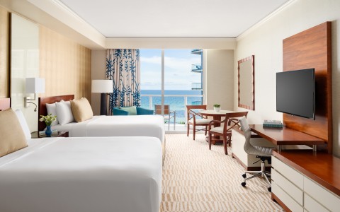 a room with two beds and a television