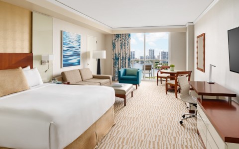 a hotel room with a large bed and a desk