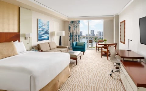 a hotel room with a large bed and a desk