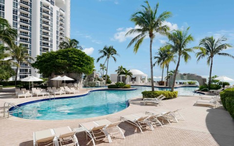 a pool with lounge chairs and palm trees