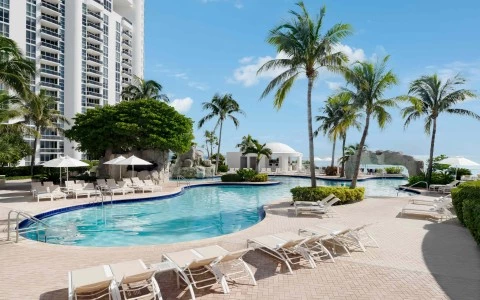 a pool with lounge chairs and palm trees