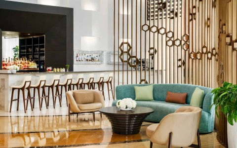 a room with a couch and chairs