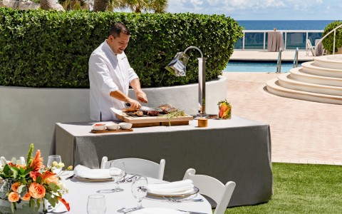 a man cooking food on a table