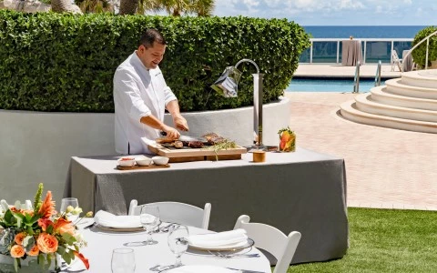 a man cooking food on a table