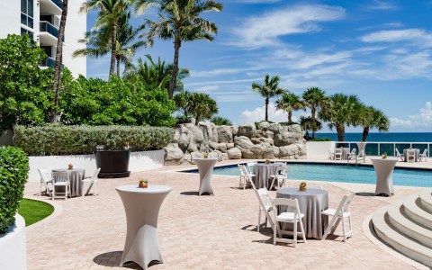 a pool with tables and chairs