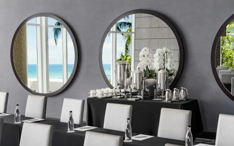 a table with a mirror and chairs