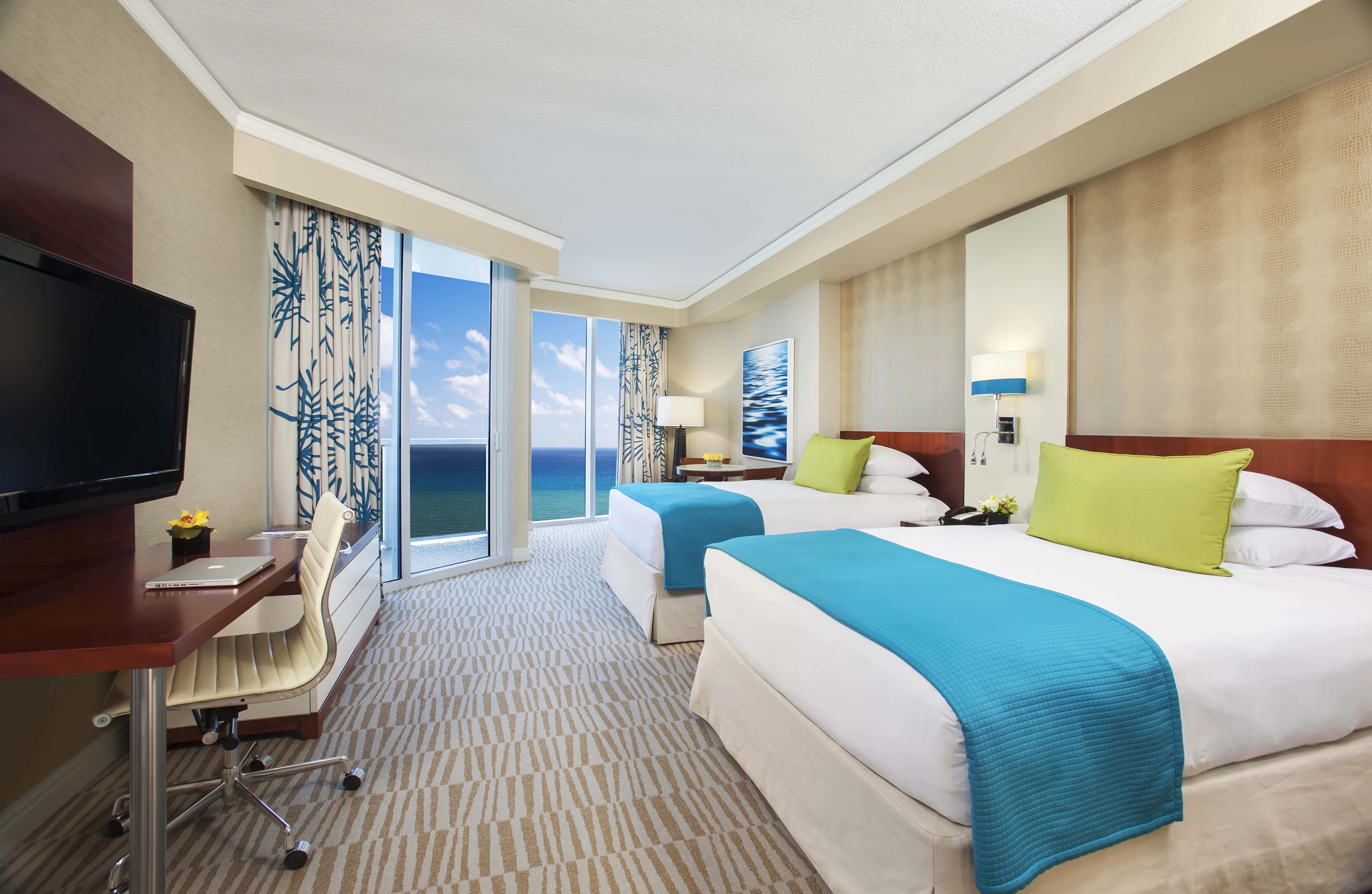 a hotel room with two beds and a desk