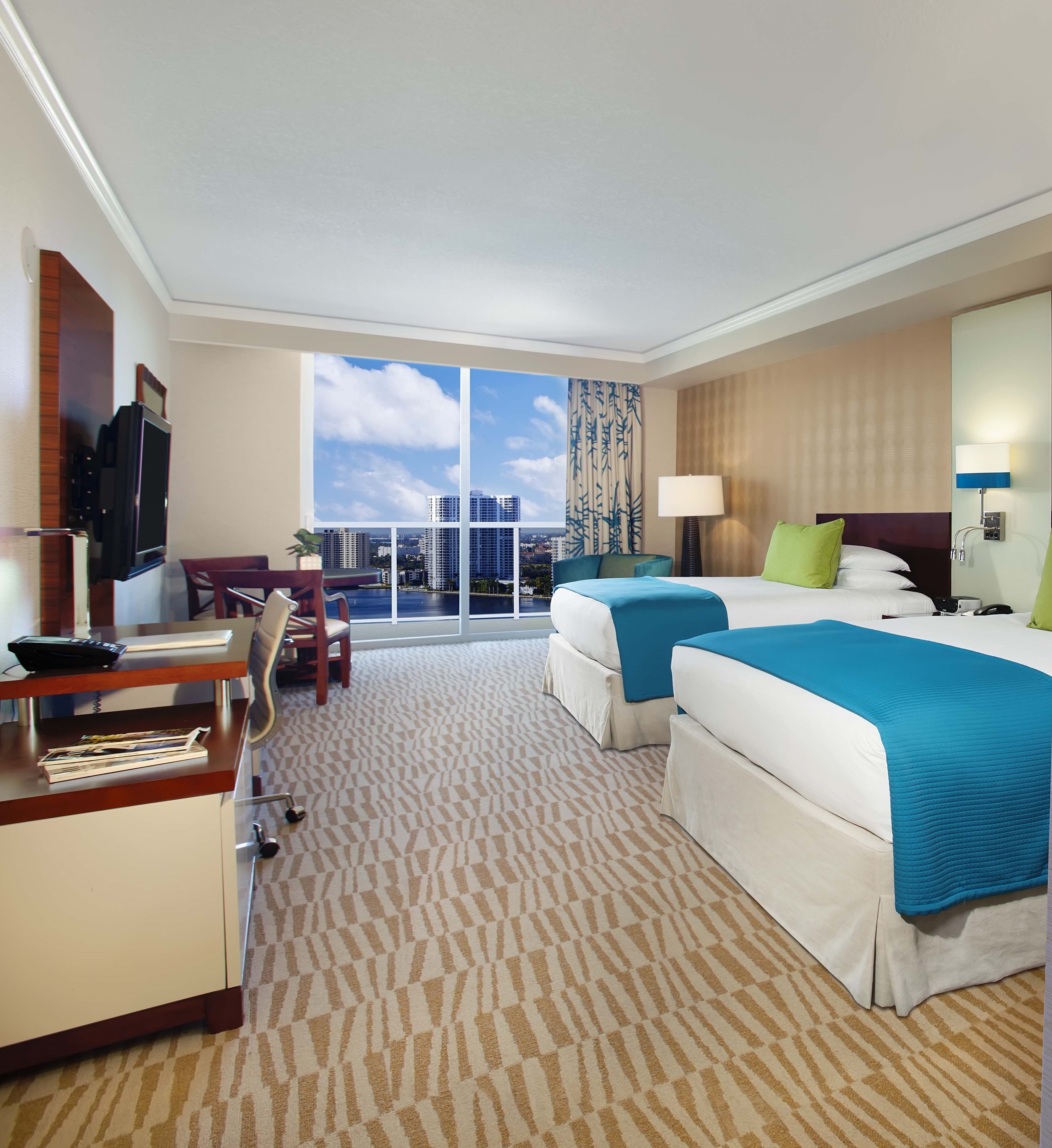 a hotel room with two beds and a television