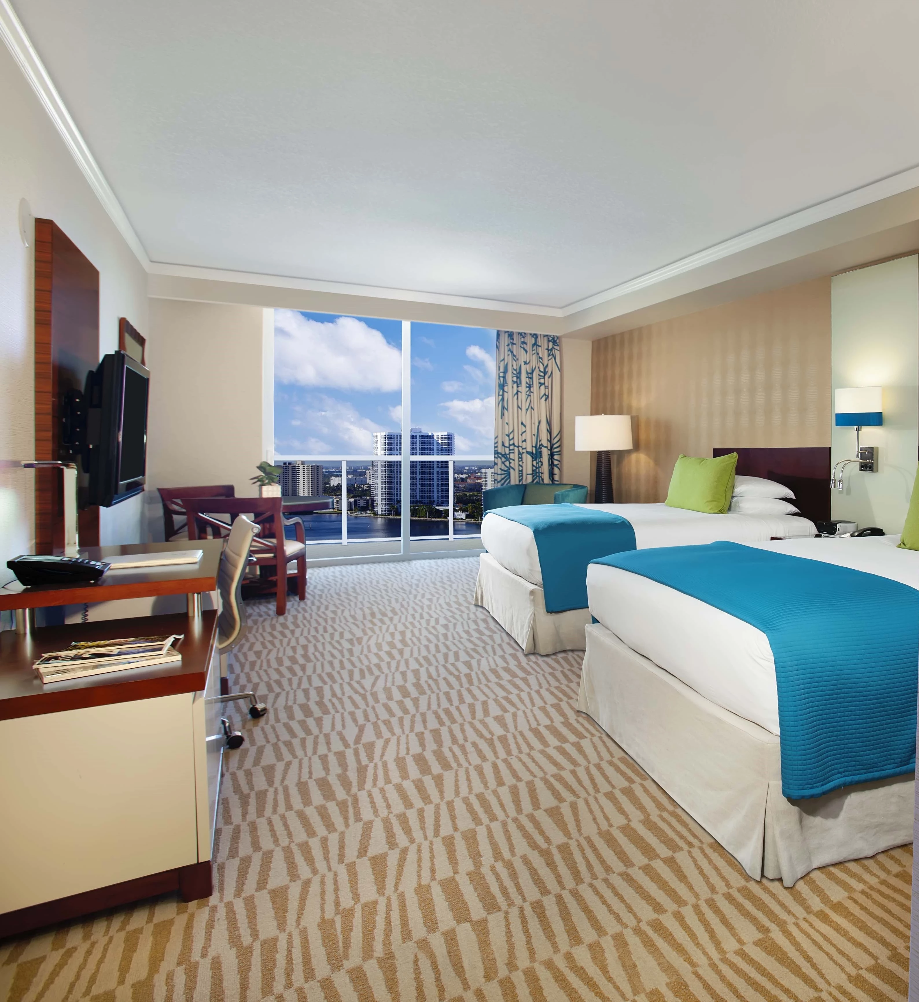 a hotel room with two beds and a television