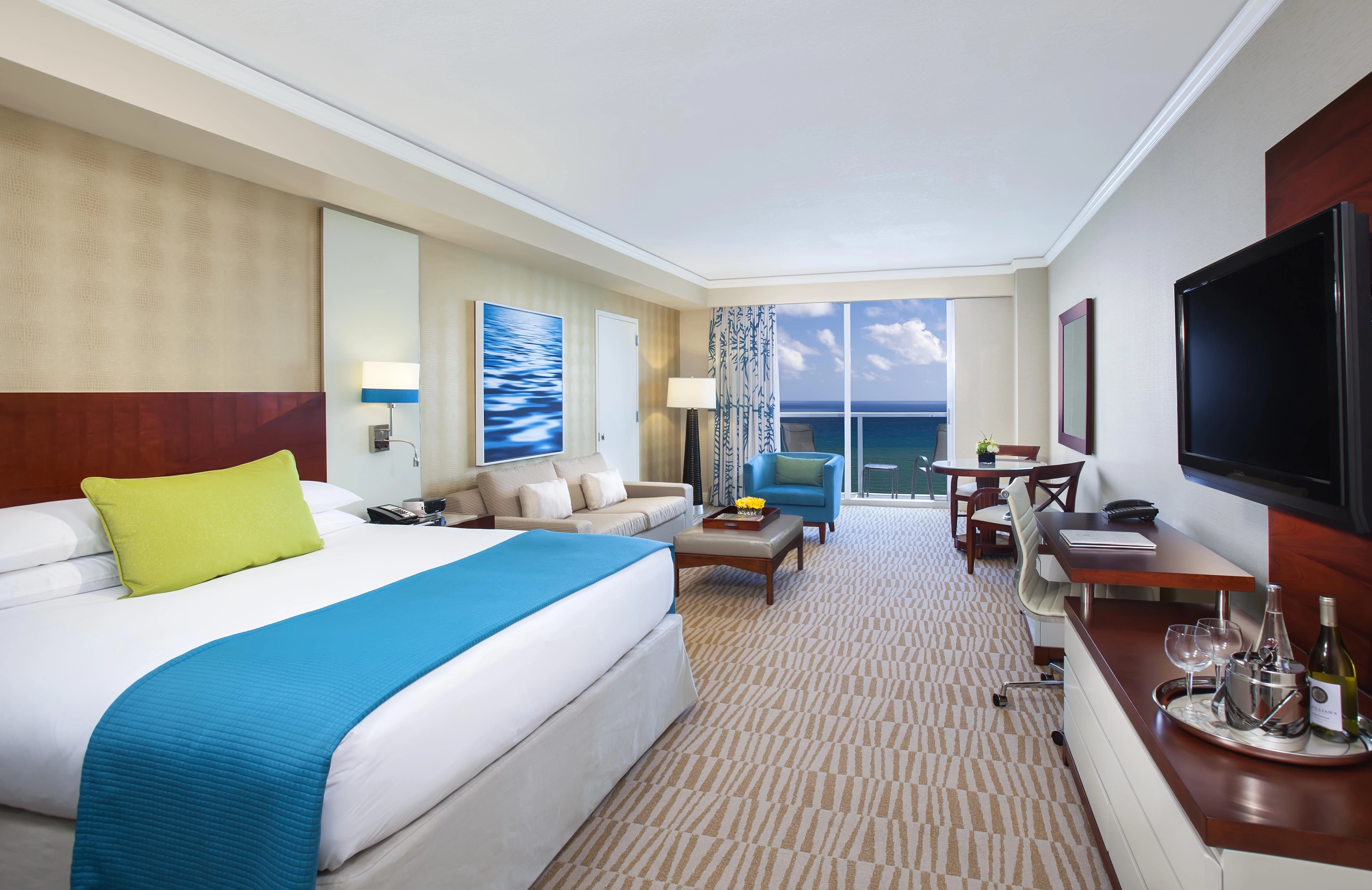 a room with a bed and a table and chairs