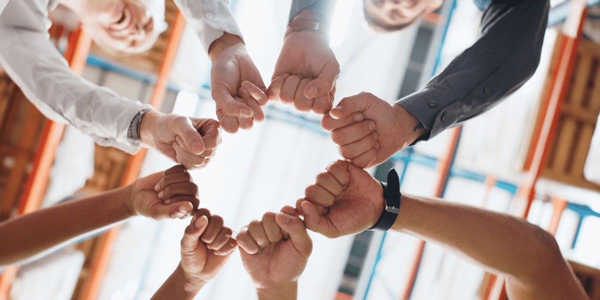 a group of people holding their fists together