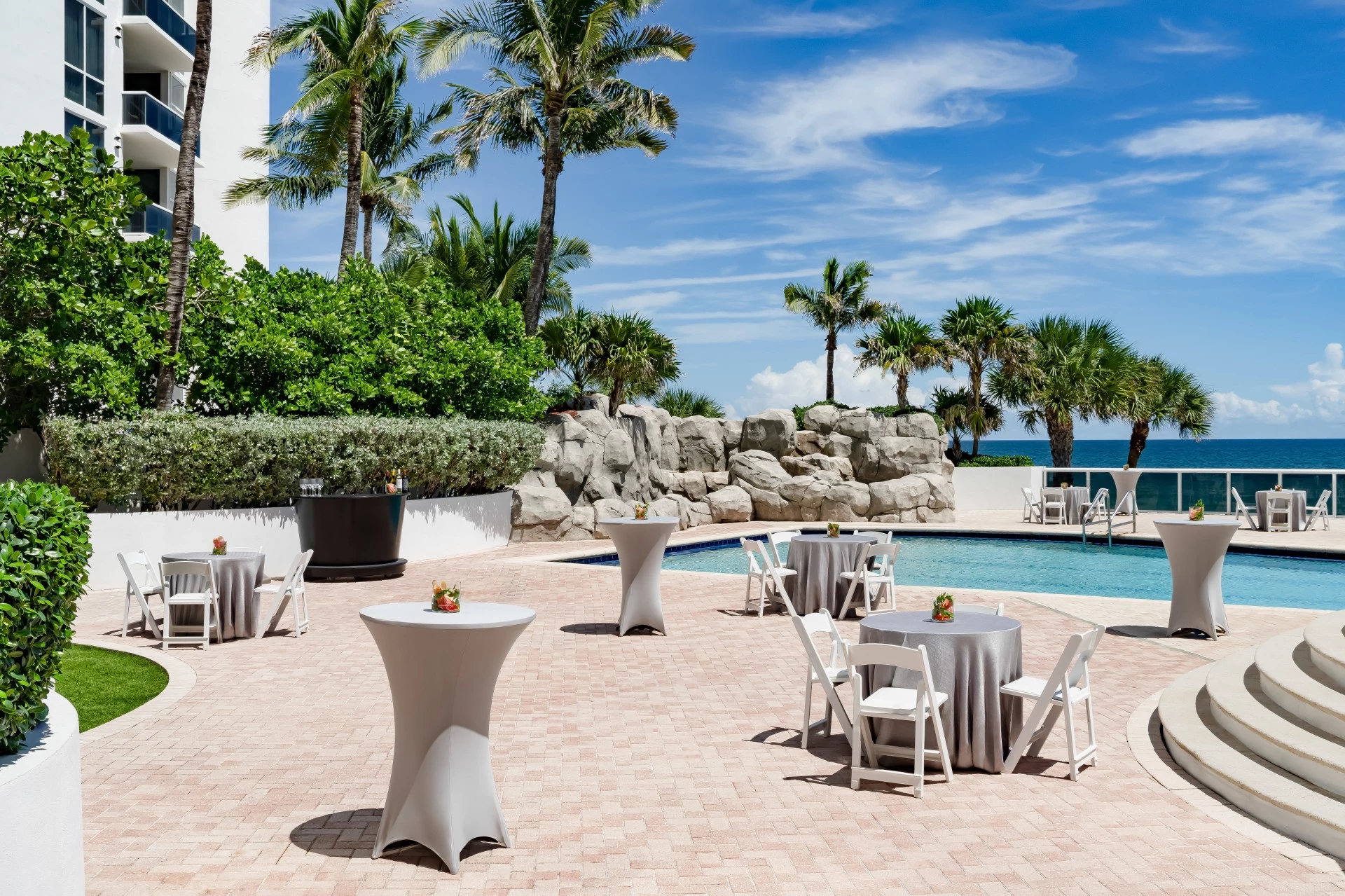 a pool with tables and chairs
