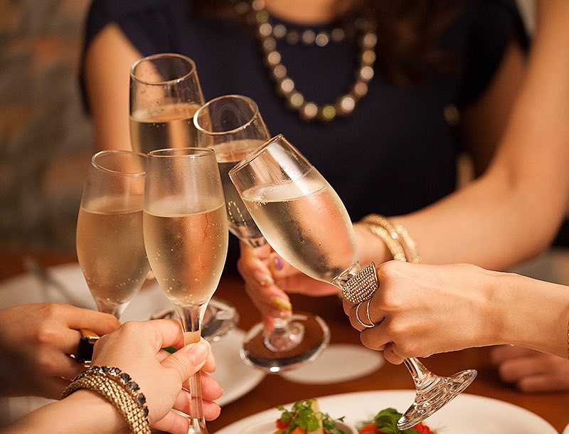 a group of people holding champagne glasses