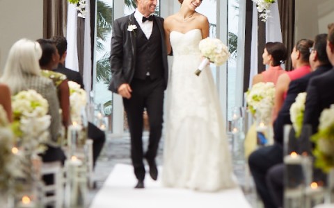 a man and woman walking down a aisle