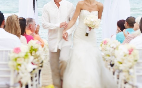 a man and woman walking down a beach