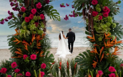 a bride and groom walking on a beach