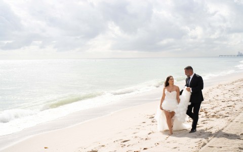 a man and woman walking on a beach