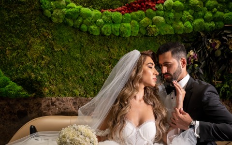 a man and woman in wedding attire sitting on a couch