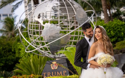 a man and woman in front of a statue