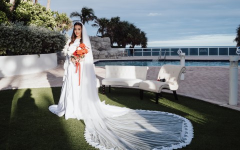 a woman in a white dress holding a bouquet of flowers