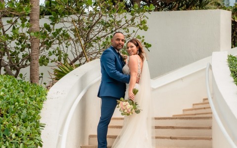a man and woman posing for a picture on stairs
