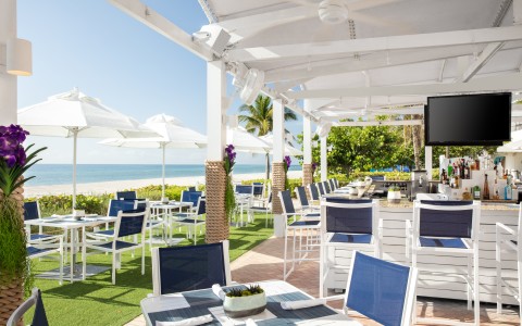 a restaurant with tables and chairs on a beach