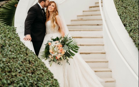 a man and woman kissing on stairs