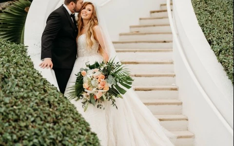 a man and woman kissing on stairs