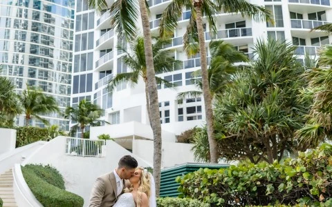 a man and woman kissing in front of a building