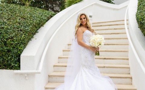 a woman in a wedding dress holding a bouquet of flowers