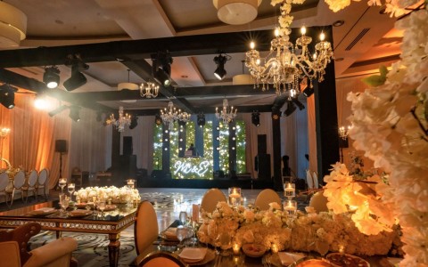 a room with tables and chandeliers