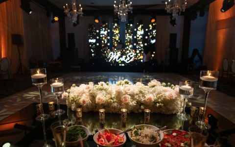 a table with flowers and candles