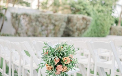 a group of white chairs with flowers on them