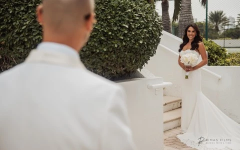 a man in a white suit and a woman in a white dress
