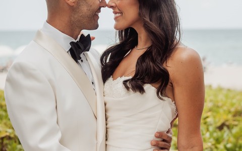 a man and woman in white suit and white suit holding each other