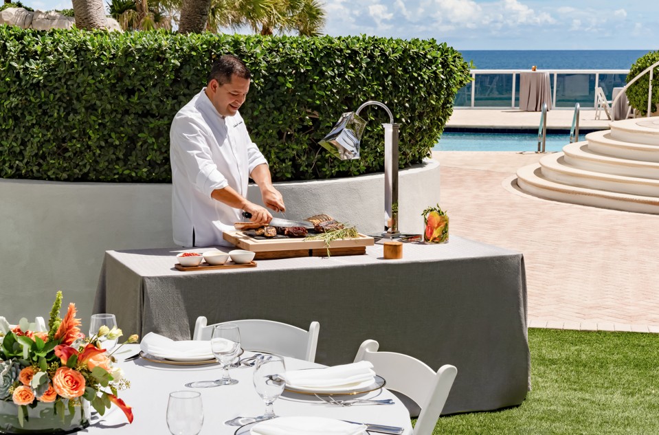 a man cutting meat on a table