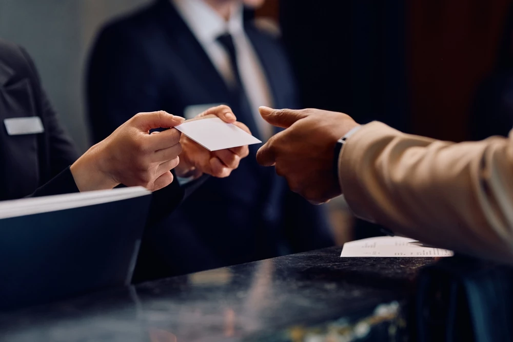 a person handing over a business card to another person