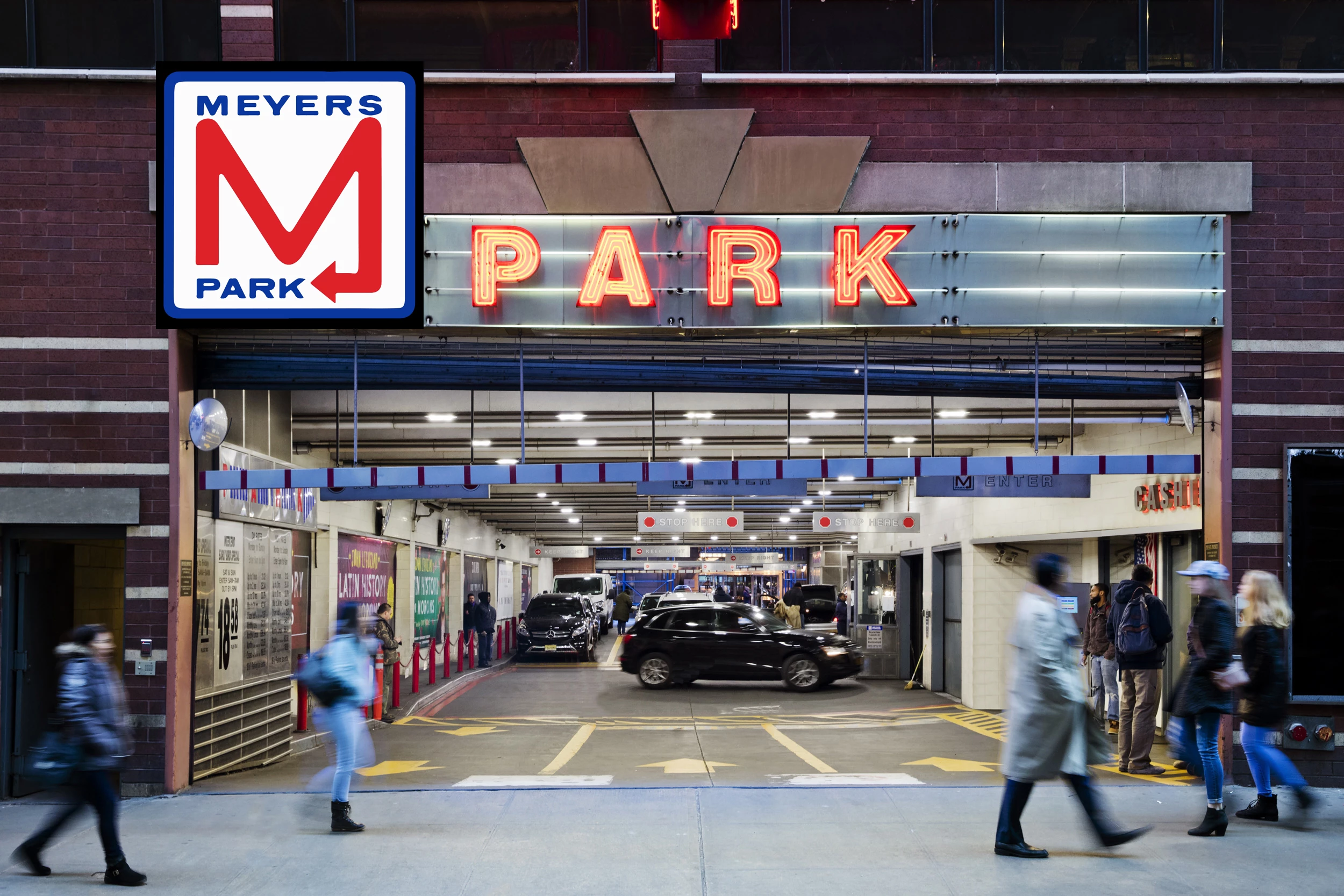 a parking garage with a sign and people walking