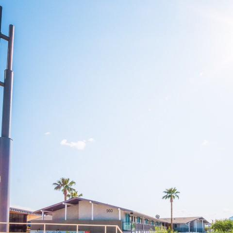 a sign with a building in the background