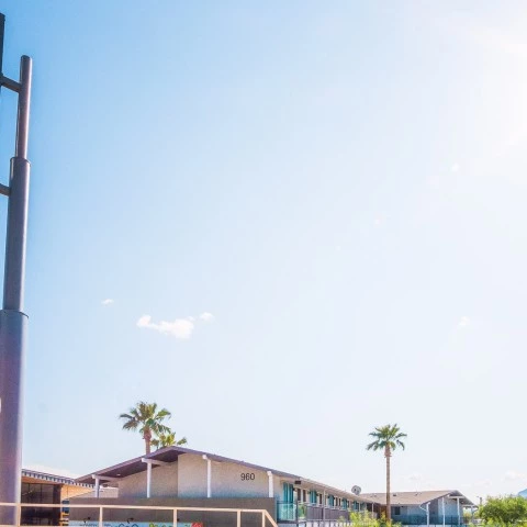 a sign with a building in the background