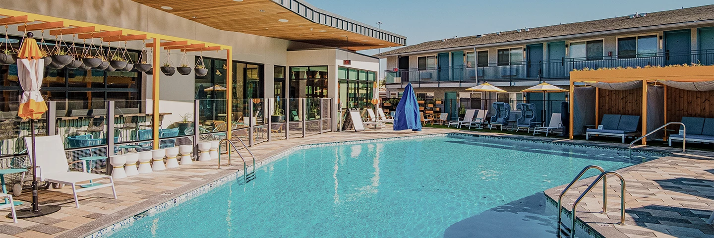 a swimming pool with a building and a pool